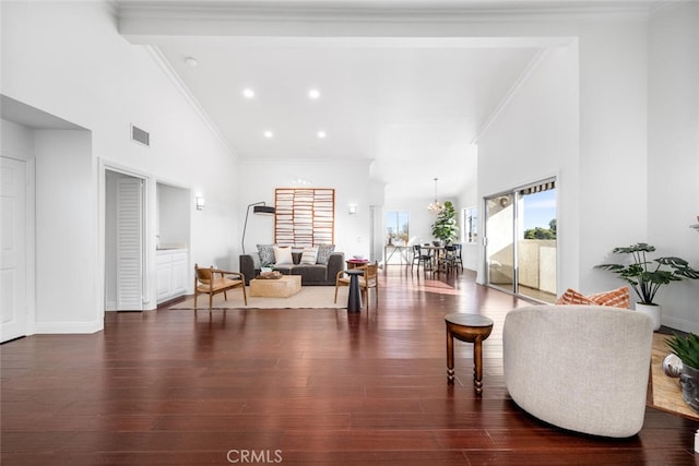 living room with high vaulted ceiling, crown molding, and dark hardwood / wood-style floors