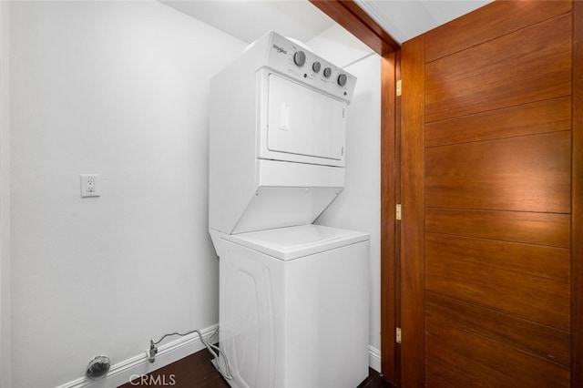 clothes washing area with stacked washer and clothes dryer