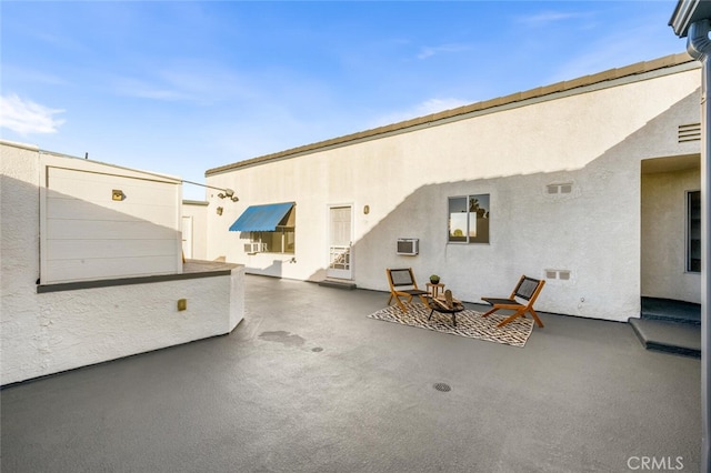 view of patio with a wall mounted AC