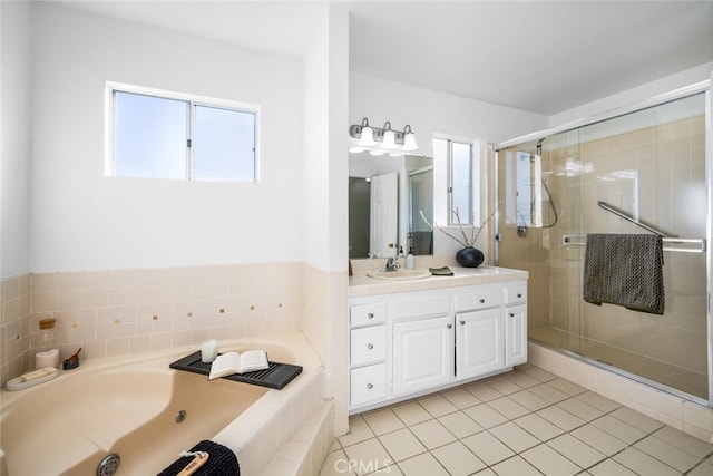 bathroom with tile patterned flooring, vanity, and shower with separate bathtub