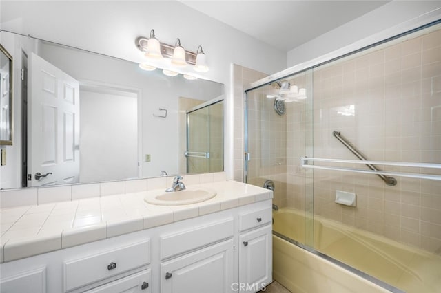 bathroom with shower / bath combination with glass door and vanity