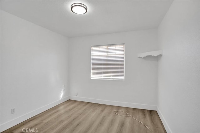 unfurnished room with light wood-type flooring