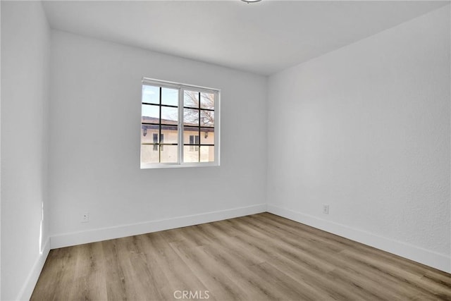 spare room featuring light wood-type flooring