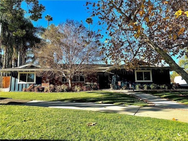 single story home featuring a front lawn