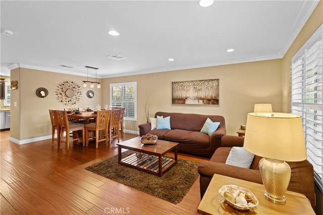 living room with hardwood / wood-style floors and ornamental molding