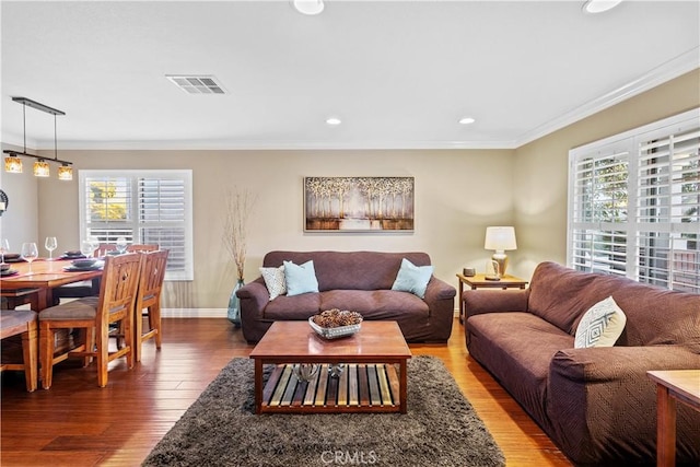 living room featuring ornamental molding and hardwood / wood-style flooring