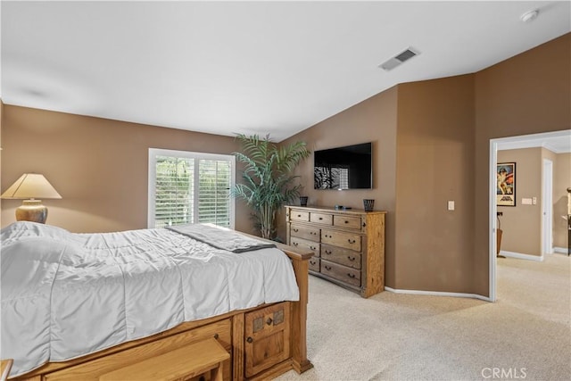 bedroom with light colored carpet and vaulted ceiling