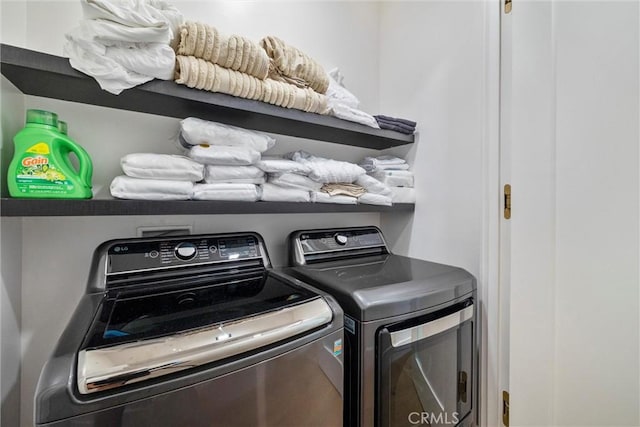 laundry area with independent washer and dryer