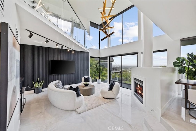 living room featuring a towering ceiling and track lighting