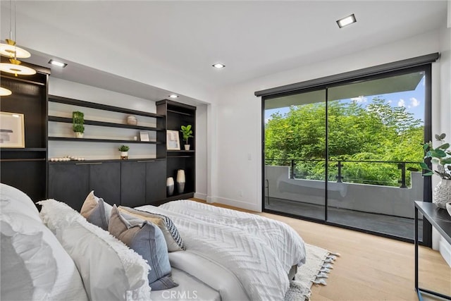 bedroom with access to outside and light wood-type flooring