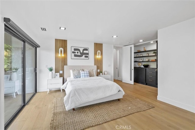 bedroom featuring light hardwood / wood-style flooring and access to outside