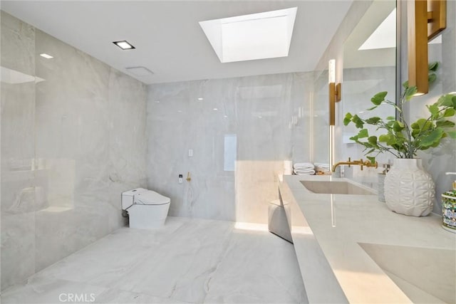 bathroom with vanity, toilet, and a skylight