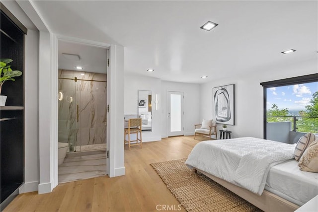 bedroom featuring ensuite bathroom and light hardwood / wood-style floors