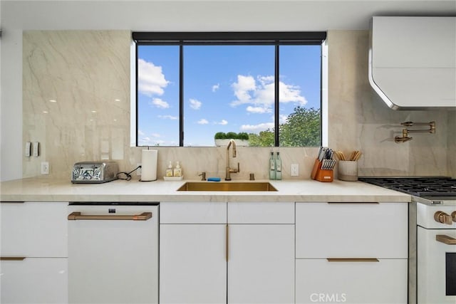 kitchen featuring sink, white cabinetry, white dishwasher, range with gas stovetop, and decorative backsplash