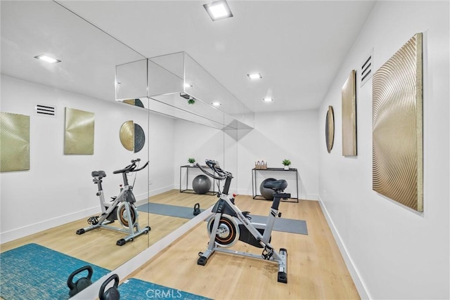 exercise area featuring hardwood / wood-style floors