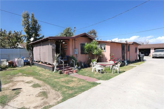 2147 E 119th St, Los Angeles, CA 90059 - view of front facade with an outbuilding, fence, and stucco siding