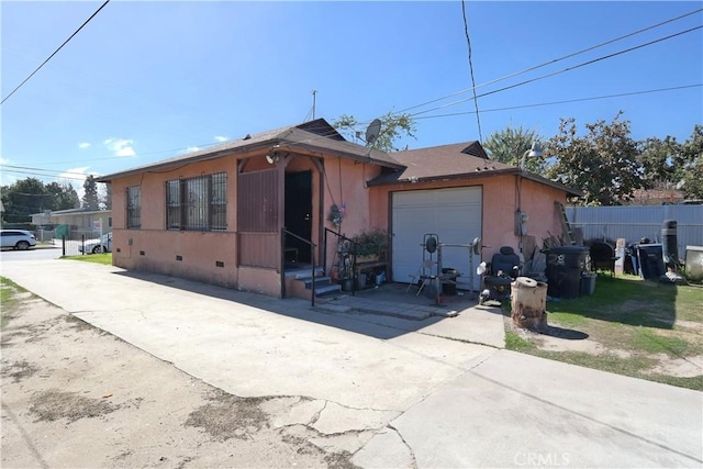 2147 E 119th St, Los Angeles, CA 90059 - view of front facade featuring stucco siding, concrete driveway, an attached garage, crawl space, and fence