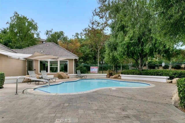 view of swimming pool featuring a patio area