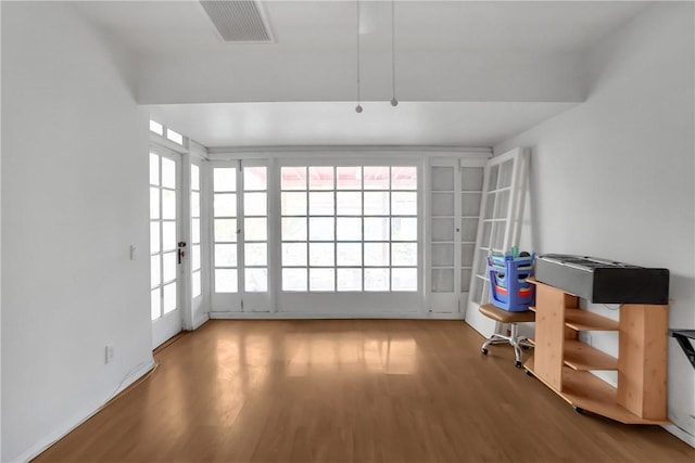 interior space with hardwood / wood-style flooring and french doors