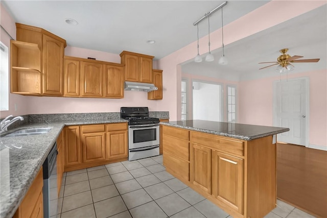 kitchen featuring track lighting, stainless steel appliances, sink, stone countertops, and ceiling fan