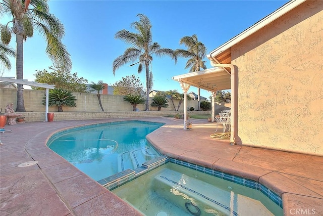 view of swimming pool featuring an in ground hot tub and a patio