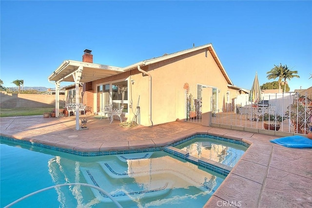 view of swimming pool with a patio and an in ground hot tub