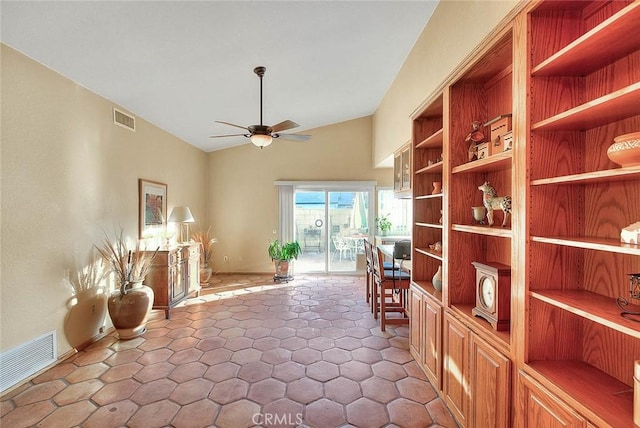 sitting room with ceiling fan and vaulted ceiling