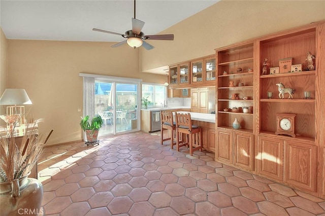 kitchen featuring a kitchen breakfast bar, ceiling fan, and dishwasher