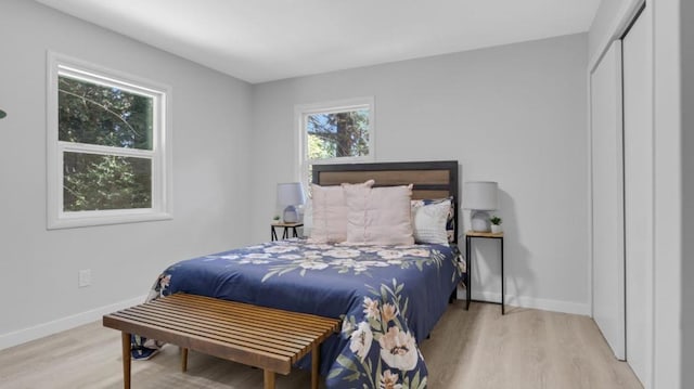 bedroom with light wood-type flooring and a closet