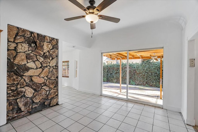 tiled empty room featuring ceiling fan