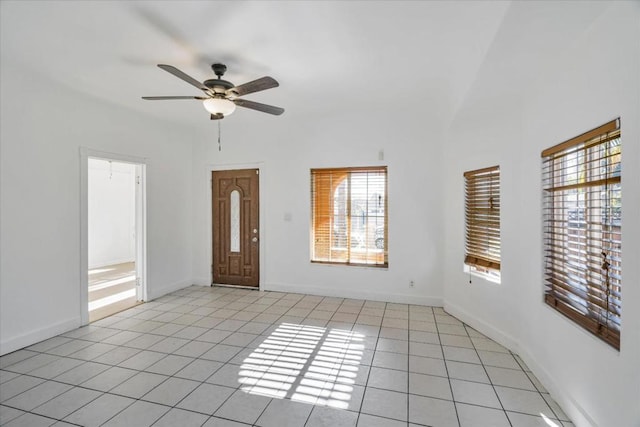 tiled empty room featuring ceiling fan