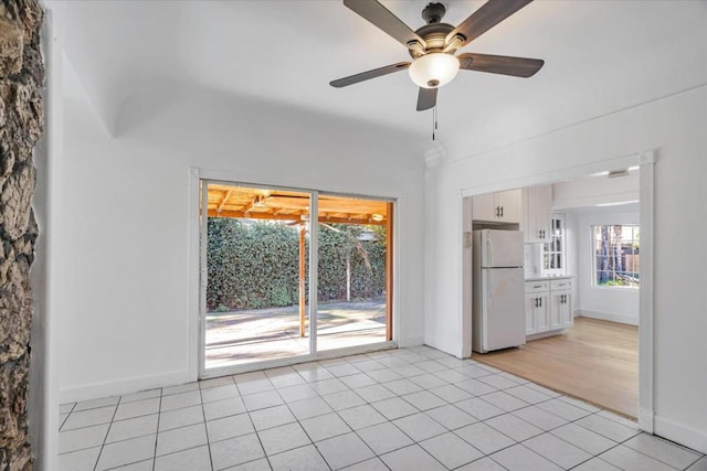 unfurnished living room with ceiling fan and light tile patterned floors