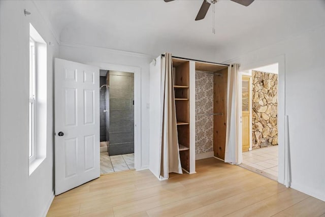 unfurnished bedroom featuring ceiling fan, connected bathroom, and light hardwood / wood-style floors