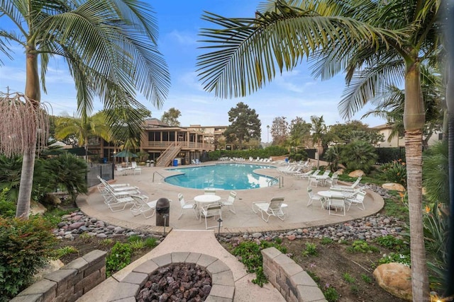 view of pool with a patio area and a fire pit