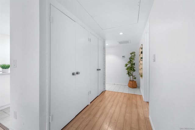 hallway with light hardwood / wood-style flooring