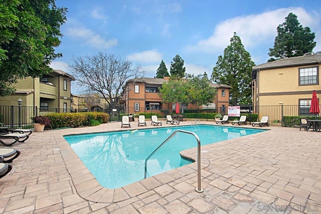 view of swimming pool with a patio area