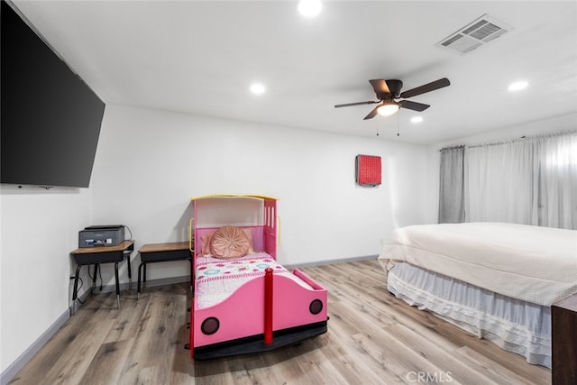 bedroom with ceiling fan and hardwood / wood-style flooring