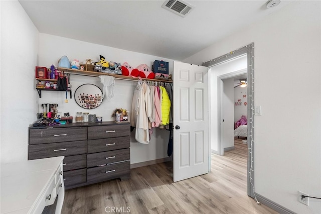 walk in closet featuring light hardwood / wood-style flooring