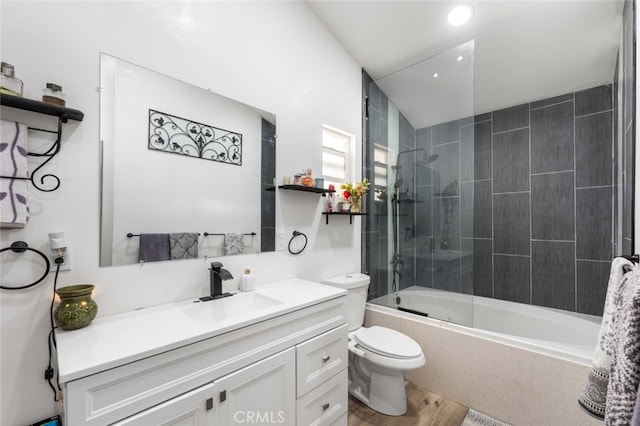 full bathroom with toilet, bath / shower combo with glass door, wood-type flooring, and vanity