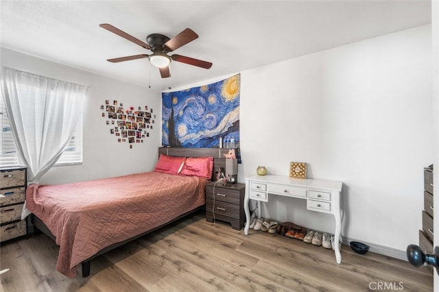 bedroom featuring ceiling fan and wood-type flooring