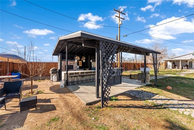 view of patio / terrace featuring a gazebo, a bar, and area for grilling