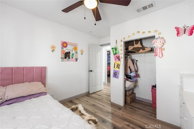 bedroom featuring ceiling fan, a closet, and light hardwood / wood-style flooring