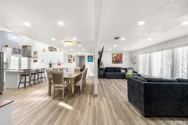 dining space with light hardwood / wood-style floors