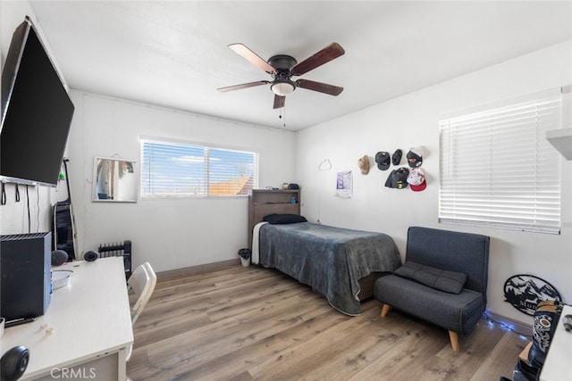 bedroom featuring ceiling fan and light hardwood / wood-style floors