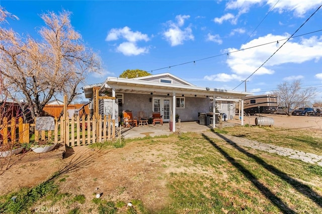 rear view of house featuring french doors, a patio area, and a yard