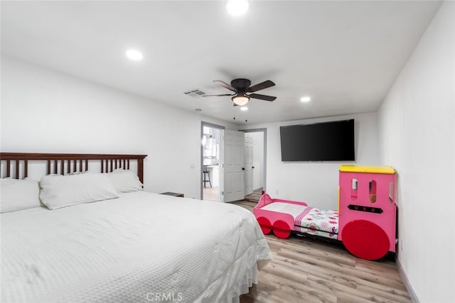 bedroom with ceiling fan and light hardwood / wood-style floors