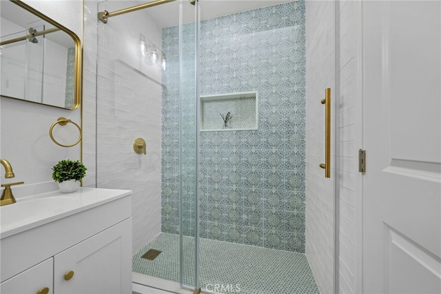 bathroom featuring an enclosed shower and vanity