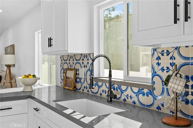 kitchen featuring sink and white cabinets