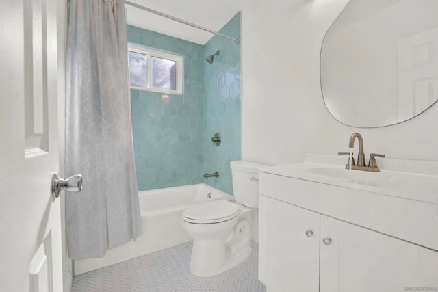 full bathroom featuring tile patterned flooring, shower / bath combination with curtain, vanity, and toilet