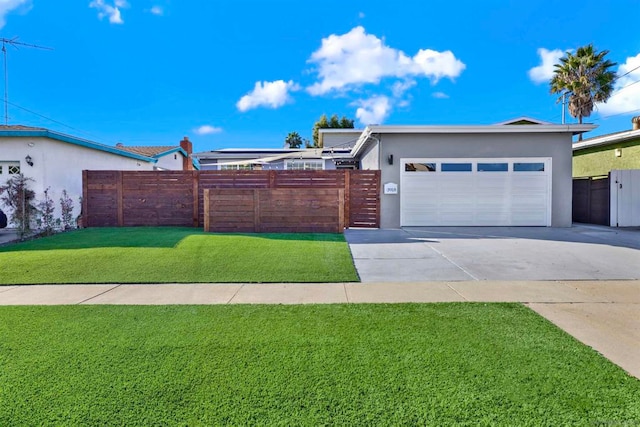 view of front of property with a front yard and a garage